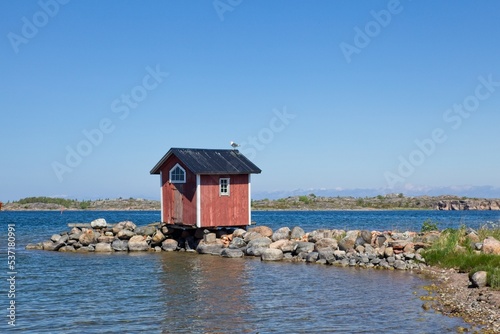 Small red wooden cabin on the island of Utö, Archipelago Sea, Finland. photo
