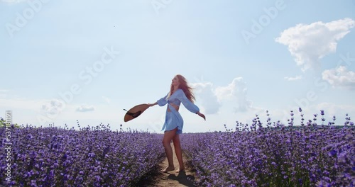 happy girl walks through a field of flowers photo
