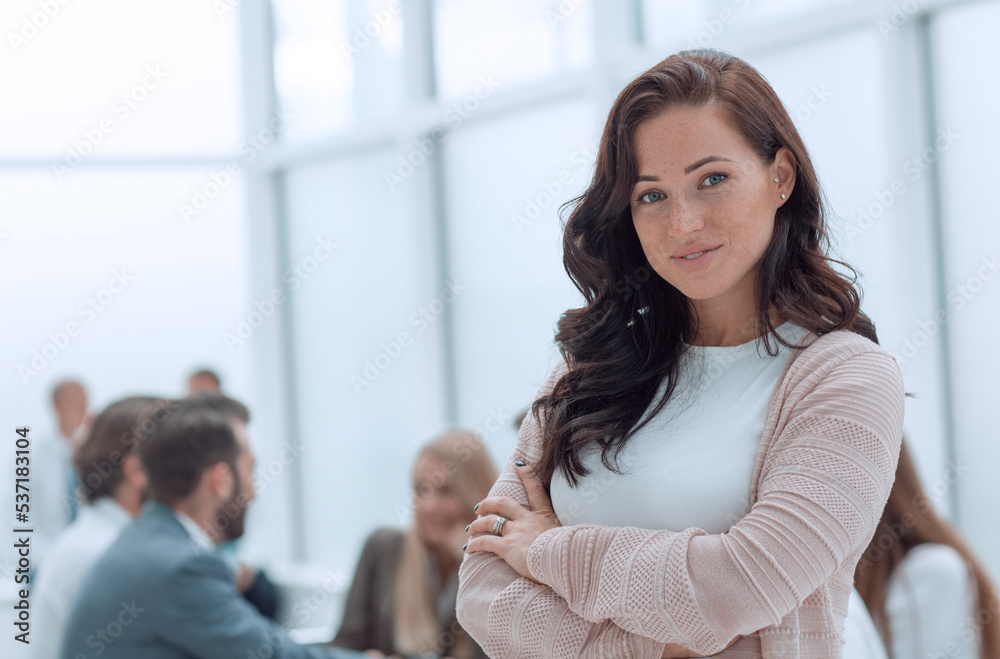 confident young business woman on the background of the office. confident young business woman on the background of the office.