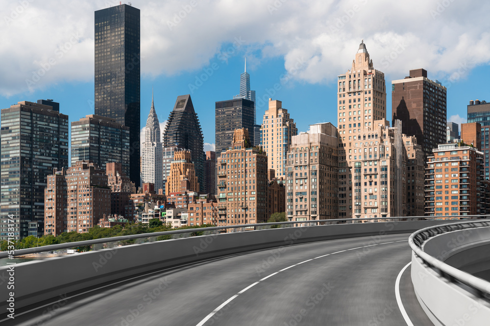 Fototapeta premium Empty urban asphalt road exterior with city buildings background. New modern highway concrete construction. Concept of way to success. Transportation logistic industry fast delivery. New York. USA.