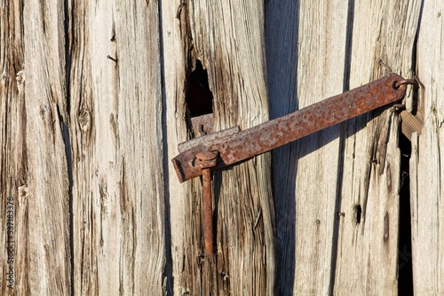 Latch on a door on a aged wooden building.