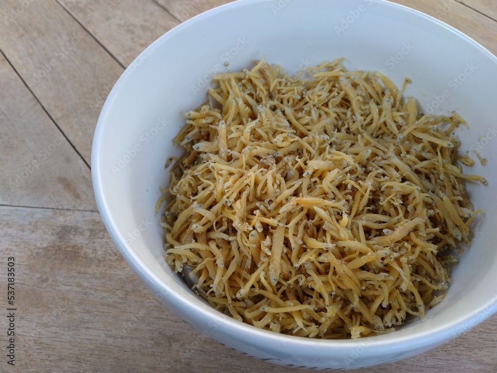 Fried anchovy placed in a white bowl