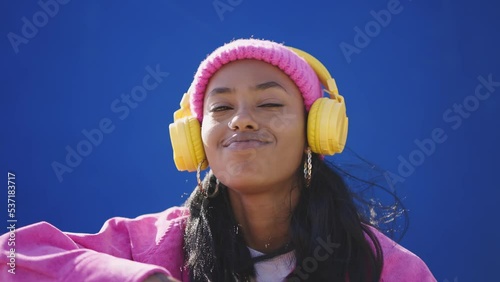 Cinematic footage of a professional hip hop female dancer outddor . Teenager girl with fashionable clothes dancing in a colored modern area of the city