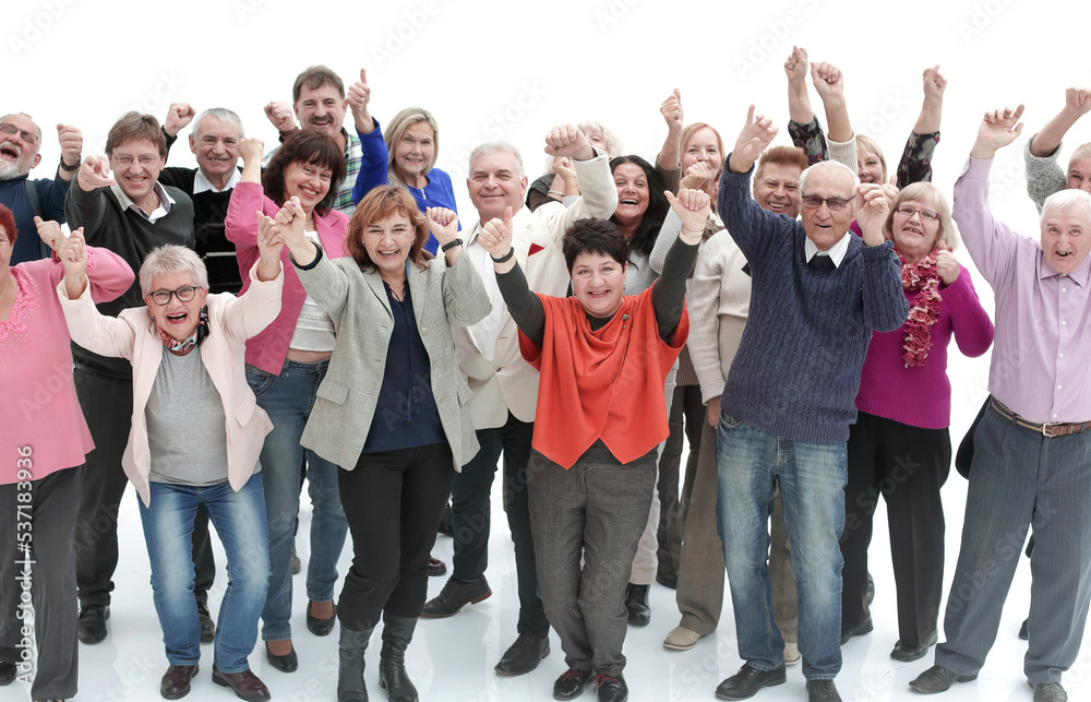 Group of smilig people with their hands in the air - isolated