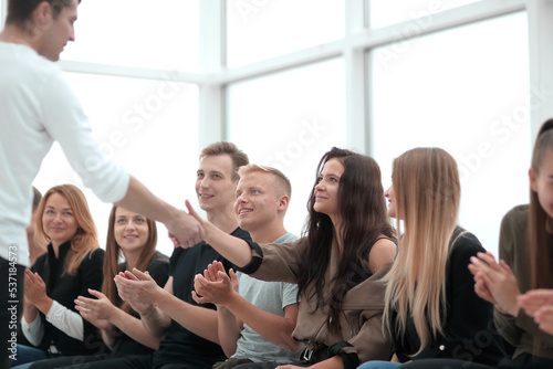 young people applaud at a group meeting.