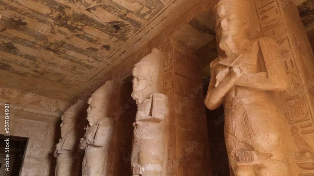 Looking Up At Sculpted Statues Inside The Great Temple Of Ramses II At Abu Simbel With Birds Flying Past Looking Up At Sculpted Statues Inside The Great Temple Of Ramses II At Abu Simbel With Birds Flying Past