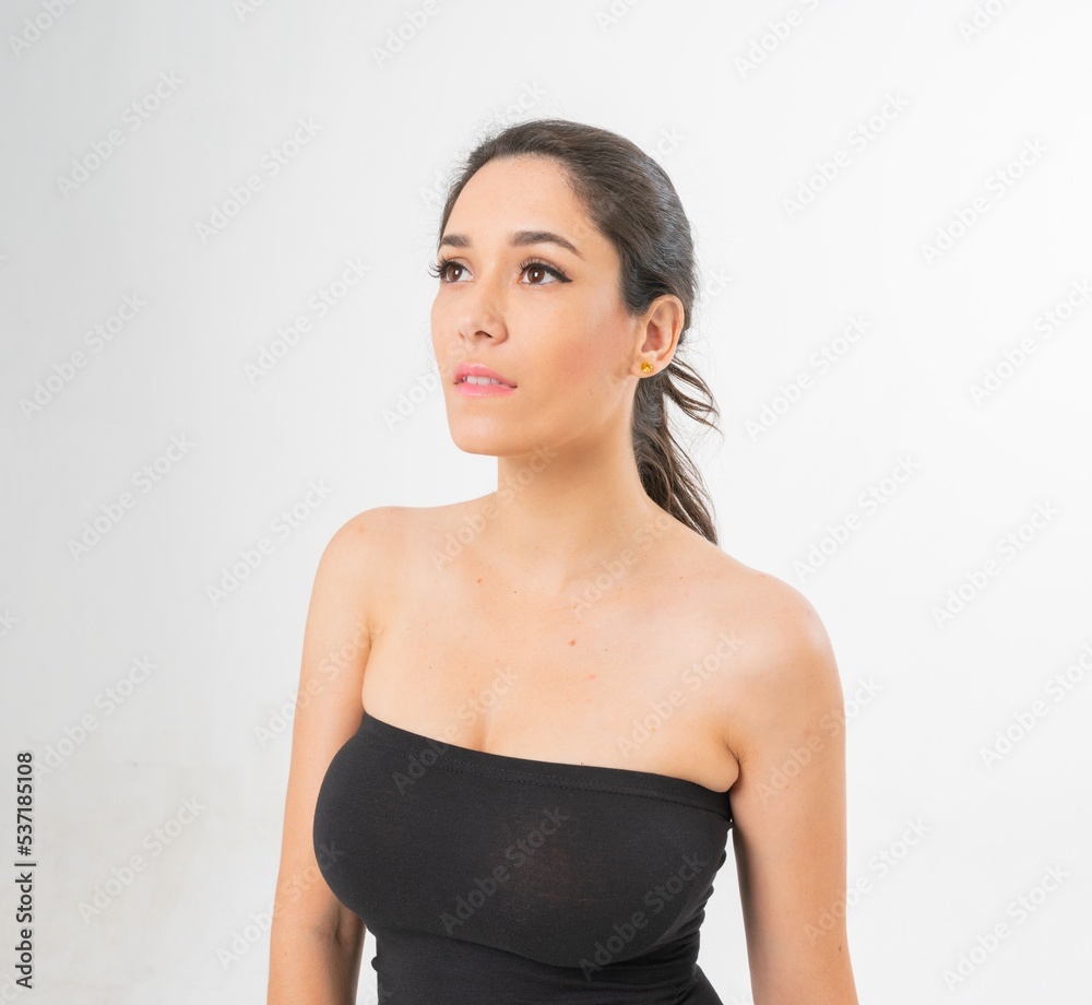 Studio portrait photo of a young beautiful elegant Brazilian female model lady wearing a black tube top posing with a series moments of emotion and gesture Studio portrait photo of a young beautiful elegant Brazilian female model lady wearing a black tube top posing with a series moments of emotion and gesture