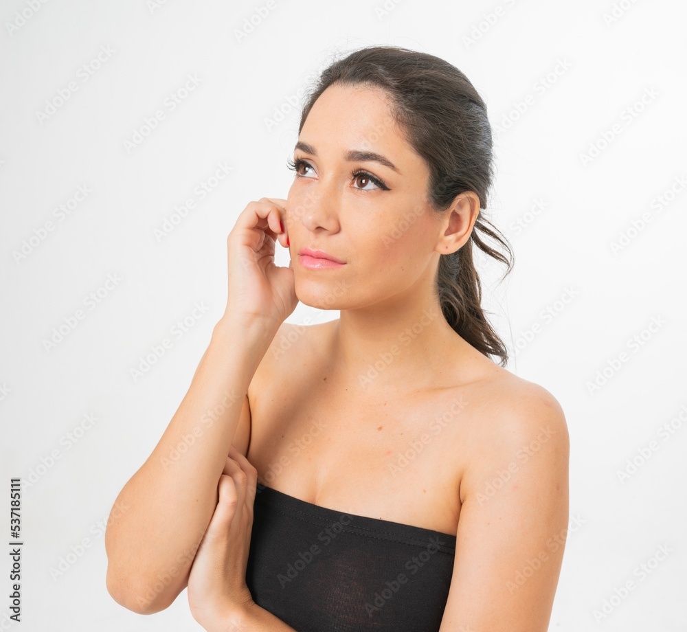 Studio portrait photo of a young beautiful elegant Brazilian female model lady wearing a black tube top posing with a series moments of emotion and gesture Studio portrait photo of a young beautiful elegant Brazilian female model lady wearing a black tube top posing with a series moments of emotion and gesture