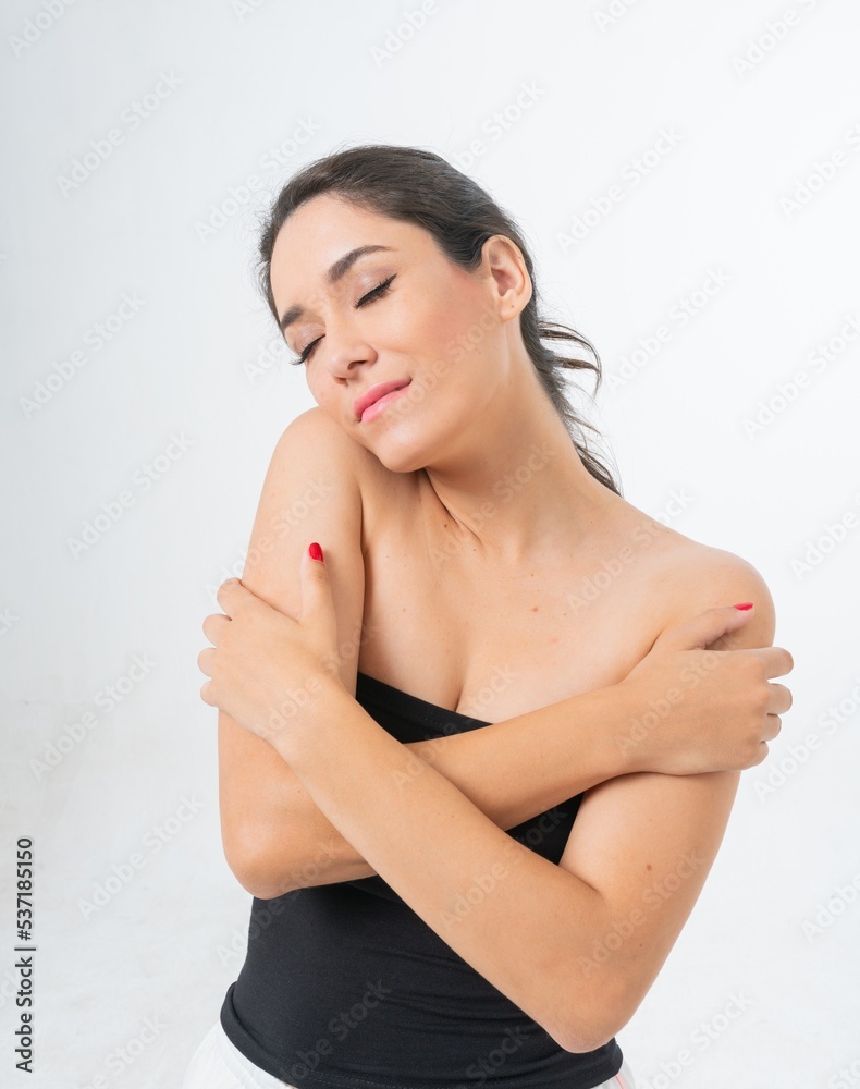 Studio portrait photo of a young beautiful elegant Brazilian female model lady wearing a black tube top posing with a series moments of emotion and gesture 