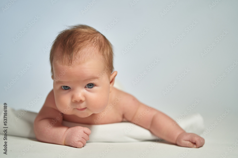 Close-up portrait of a newborn on a light background Close-up portrait of a newborn on a light background