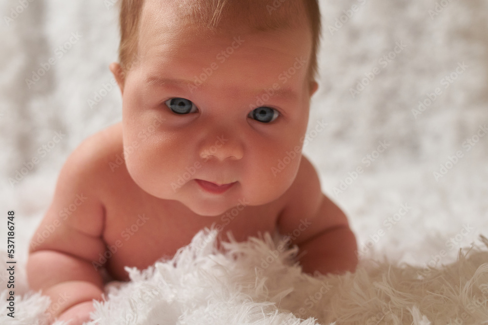Portrait of a newborn baby lying on a soft, fluffy surface