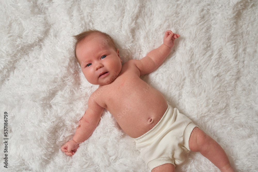Portrait of a newborn baby lying on a soft, fluffy surface Portrait of a newborn baby lying on a soft, fluffy surface