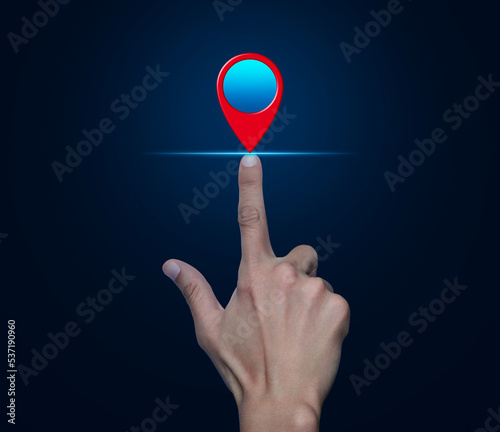 Hand pressing map pin point location button over blue background, Map pointer navigation concept, Elements of this image furnished by NASA