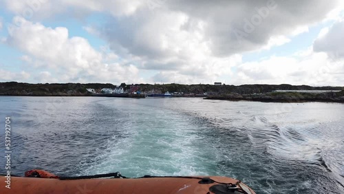 The red Arranmore ferry leaving Burtonport towards Arranmore - Burtonport, County Donegal, Ireland photo