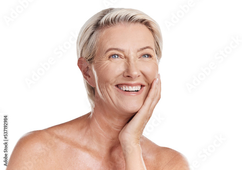 Beautiful mature caucasian woman posing topless and isolated against a pink background in a studio. Happy senior woman with glowing skin. Good skincare and a healthy routine is self care for your skin