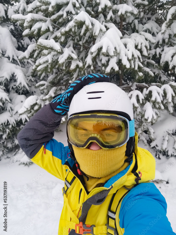 smiling woman taking selfie in ski equipment