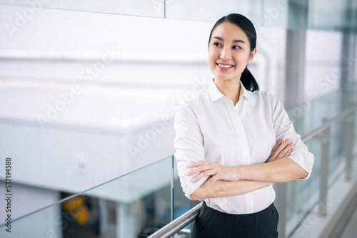 Portrait of successful business asian women in white shirt. with arms crossed and smile , Young businesswoman smiling and looking away Happy feeling concept