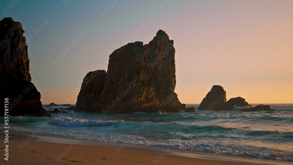 Beautiful seascape Ursa beach with rocks over Atlantic ocean surface at sunrise.