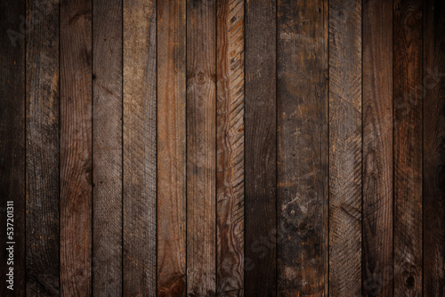 Dark vignette weathered wooden background texture from wood planks