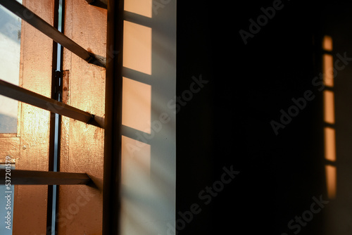 Sunlight hits the windo during evening and it's reflection inside the room