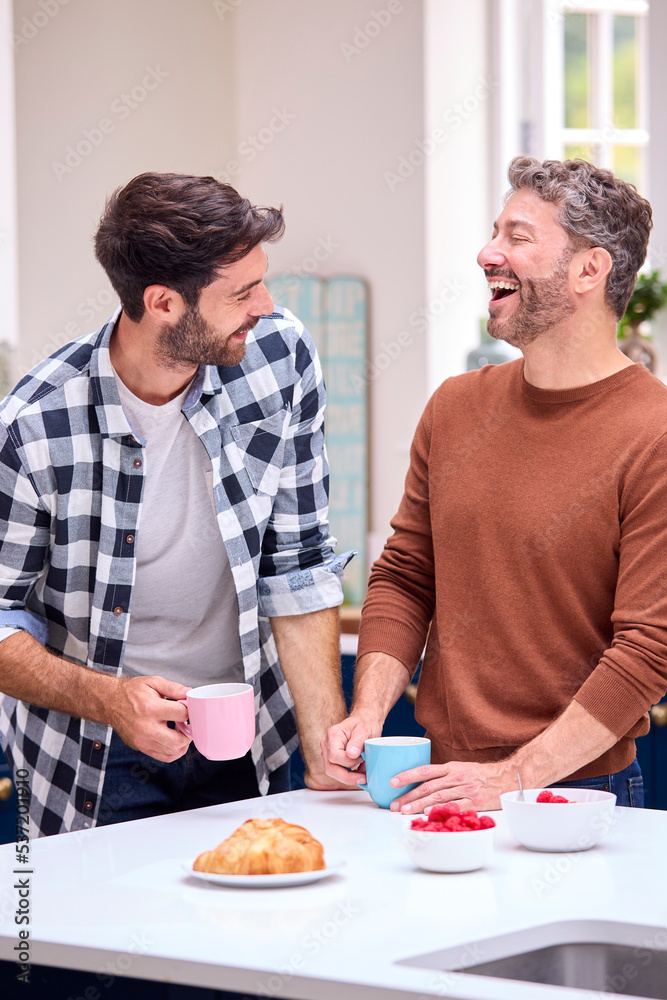 Same Sex Male Couple At Home In Kitchen Having Breakfast Together Same Sex Male Couple At Home In Kitchen Having Breakfast Together