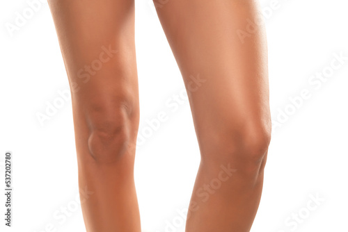 Front view of beautifully cared women's legs and knees on white background.