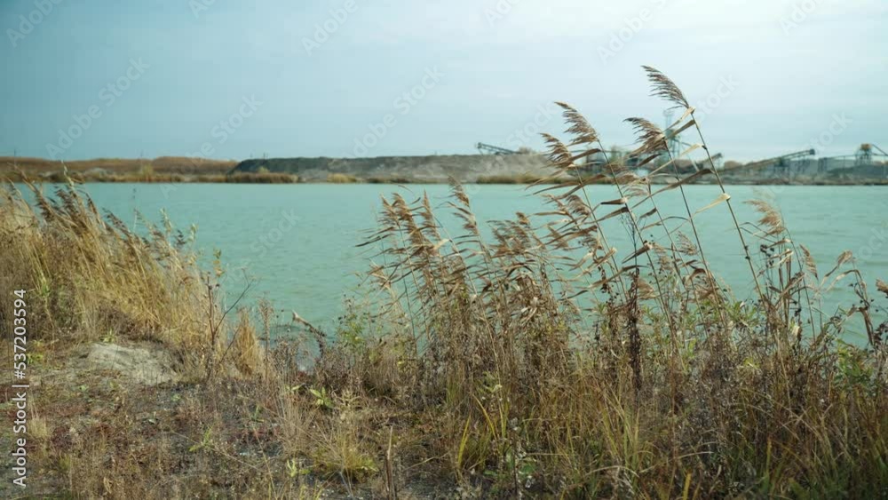 The camera moves smoothly along the shore of a suburban industrial lake. It is used for the extraction of various chemical elements and compounds. Water for cooling industrial equipment. The camera moves smoothly along the shore of a suburban industrial lake. It is used for the extraction of various chemical elements and compounds. Water for cooling industrial equipment.