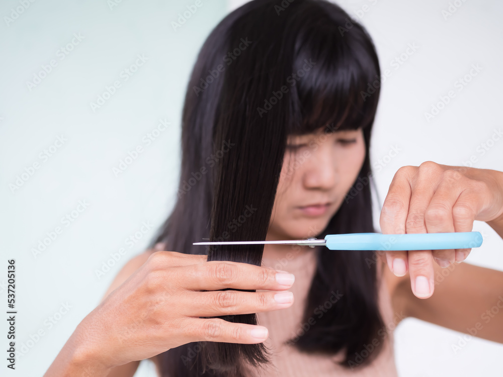 Woman holding Scissors for Cut Hair close up,Authentic Black hair and Skin Tan Asian Thailand,Beauty Fasion Lifestyle Concept. Woman holding Scissors for Cut Hair close up,Authentic Black hair and Skin Tan Asian Thailand,Beauty Fasion Lifestyle Concept.