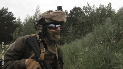 Russian soldiers with machine guns hide in the grass to attack. High quality FullHD footage