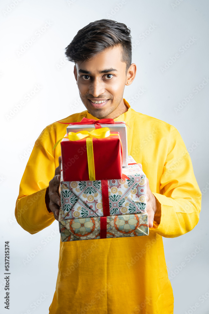 Man holding gift boxes during Diwali festival Man holding gift boxes during Diwali festival