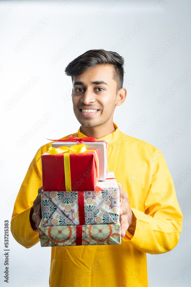 Man holding gift boxes during Diwali festival Man holding gift boxes during Diwali festival