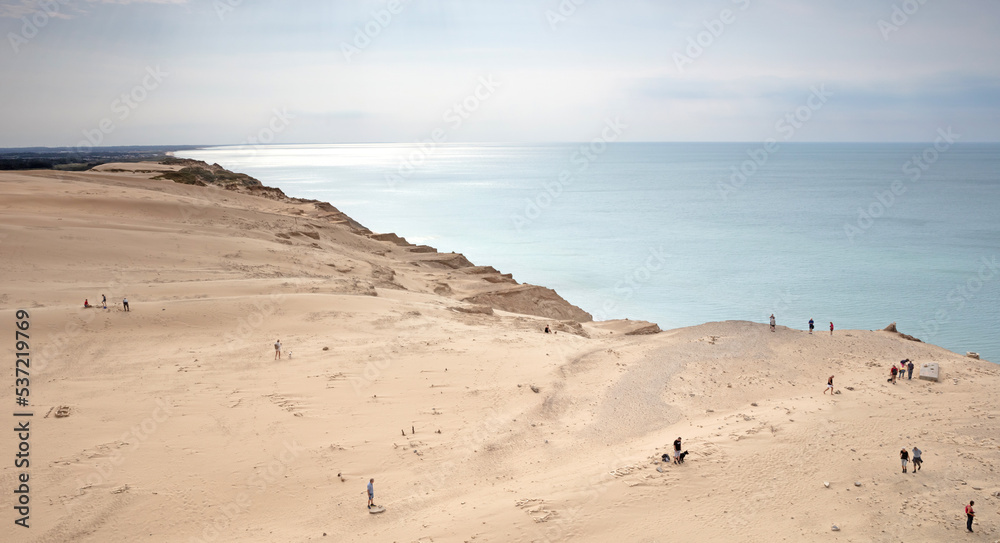 Lokken, Denmark - August 24, 2022: People at the popular Rubjerg Knude Lighthouse beach in Jutland. Lokken, Denmark - August 24, 2022: People at the popular Rubjerg Knude Lighthouse beach in Jutland.