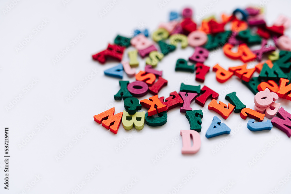 Colorful small scattered wooden letters	