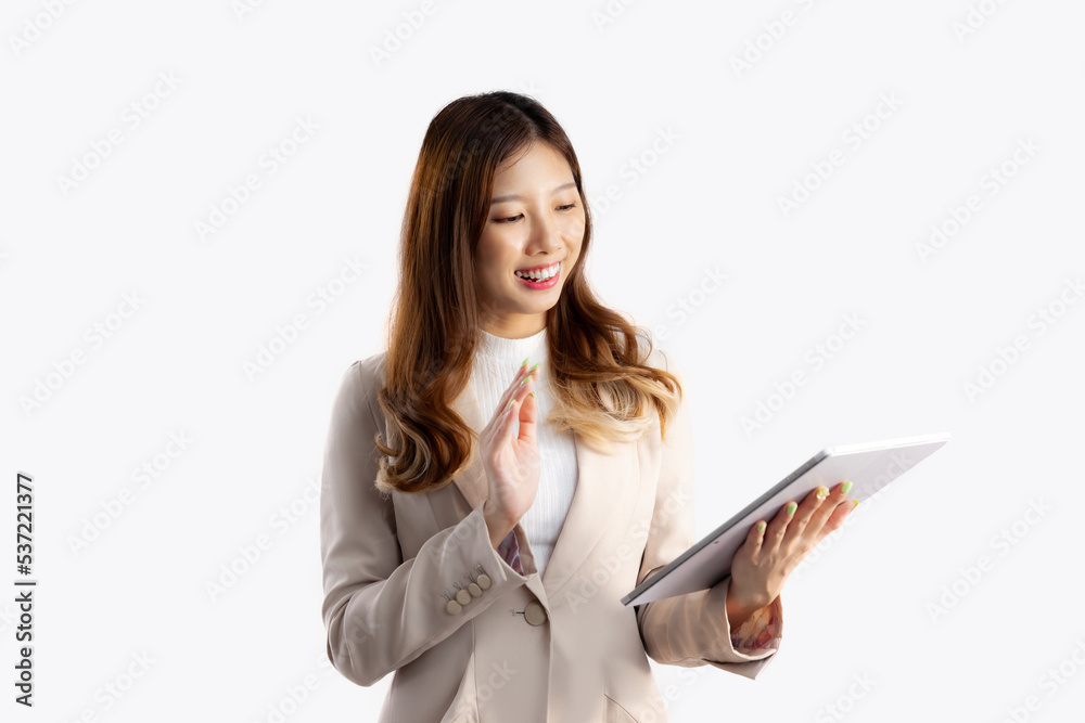 Business concept, young asian woman in beige color suit using tablet chatting talking on white background. Business concept, young asian woman in beige color suit using tablet chatting talking on white background.