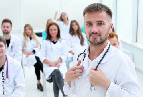 top view. a group of smiling doctors pointing at you.