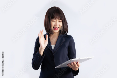 Young asian businesswoman using tablet chatting on white background.