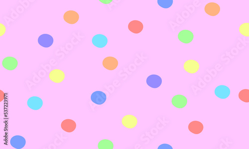 Colored polka dots on pink background seamless pattern