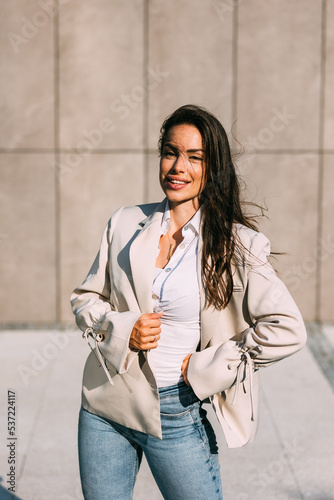 Outdoor lifestyle portrait of cheerful smiling business woman, wearing modern casual elegant outfit