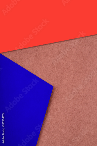 Plain and Textured brown orange blue papers randomly laying to form M like pattern and triangle for creative cover design idea