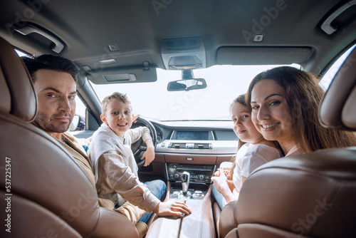 cheerful family sitting in the car © ASDF