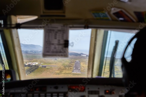 Controlling a small aircraft in the flight deck, view of the runway