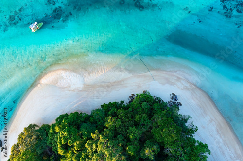Top view of white sand beach tropical with seashore as the island in a coral reef ,blue and turquoise sea Amazing nature landscape with blue lagoon