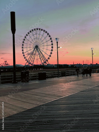pier with Ferris  wheel at dusk
