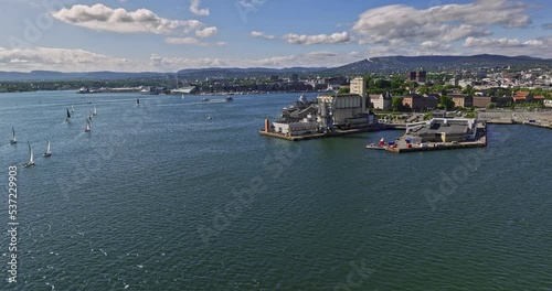 Oslo Norway v14 low level drone fly around ferry wharf capturing commercial ports and downtown cityscape across neighborhoods of sentrum on a sunny day in summer - Shot with Mavic 3 Cine - June 2022 photo