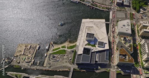 Oslo Norway v20 birds eye view drone flyover gamle waterfront neighbourhood, tilt up reveals sentrum downtown cityscape with busy central station transit hub - Shot with Mavic 3 Cine - June 2022 photo