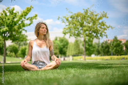 Girl practice yoga meditation outdoor in park © grthirteen