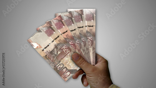 Kenya Shilling growing pile of money in hand concept 3d illustration