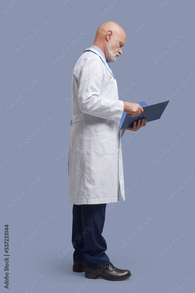 Doctor checking patient's medical records Doctor checking patient's medical records