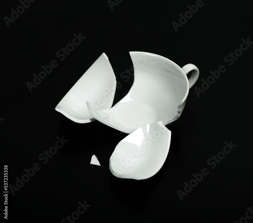 Obraz na płótnie Broken white cup on black Background