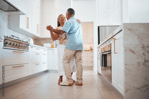 Couple, elderly and dance in kitchen for love, romance and happy together while home in retirement. Senior, man and woman do fun dancing in house for bonding, happiness and care with smile on face
